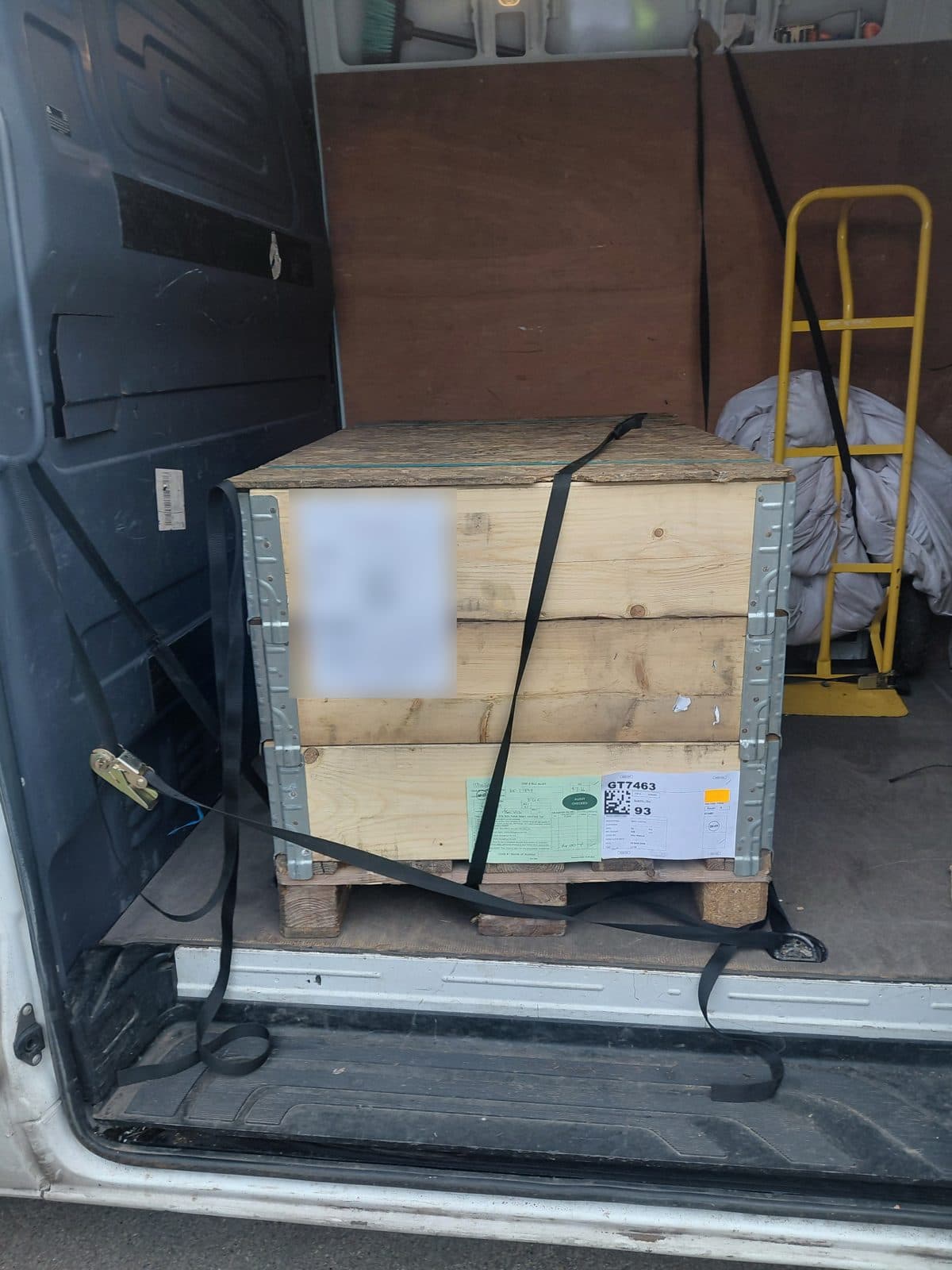 Wooden crate strapped securely in the back of a van